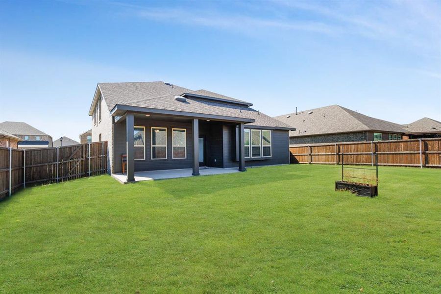 Back of property featuring a fenced backyard, a patio area, and roof with shingles Back of property featuring a fenced backyard, a patio area, and roof with shingles