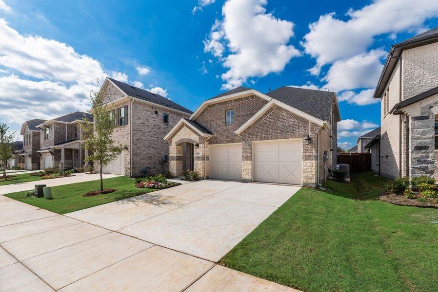 Front exterior of a new home in Spiritas Ranch, Little Elm, TX, highlighting curb appeal (Image 21). Front exterior of a new home in Spiritas Ranch, Little Elm, TX, highlighting curb appeal (Image 21).