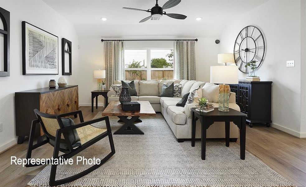 Living area featuring light wood-finish flooring, recessed lighting, and a ceiling fan Living area featuring light wood-finish flooring, recessed lighting, and a ceiling fan