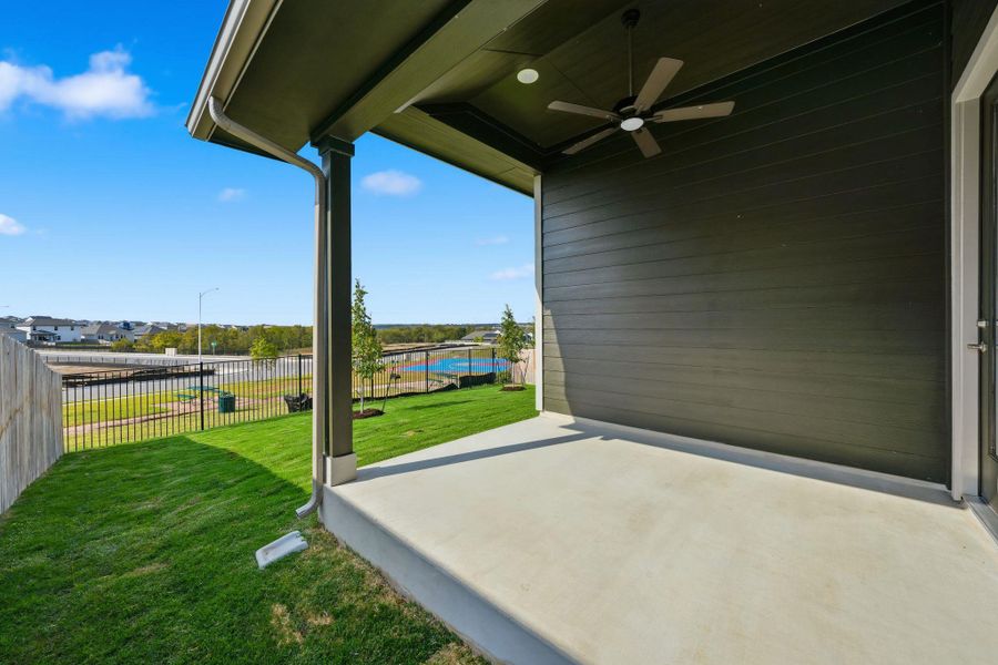 Fenced backyard with a patio and a ceiling fan Fenced backyard with a patio and a ceiling fan