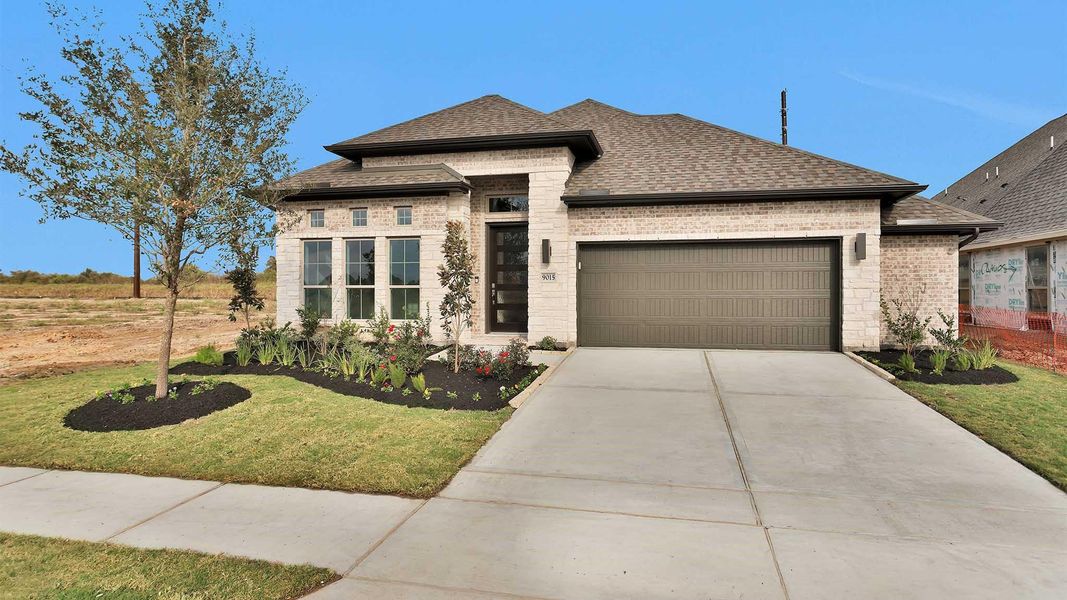 Front exterior of a new home in Meridiana 55', Manvel, TX, highlighting curb appeal (Image 2).