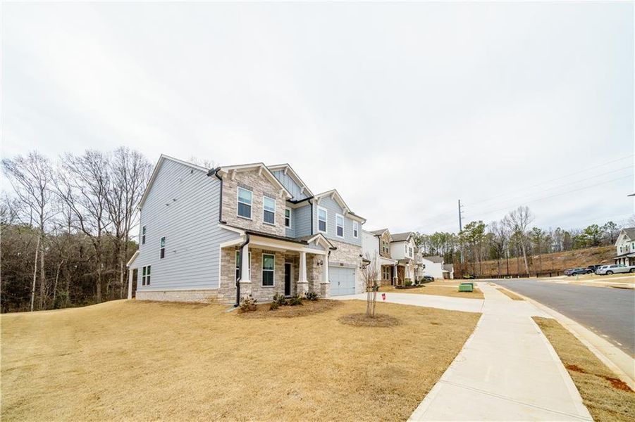 Front exterior of a new home in , Powder Springs, GA, highlighting curb appeal (Image 36). Front exterior of a new home in , Powder Springs, GA, highlighting curb appeal (Image 36).
