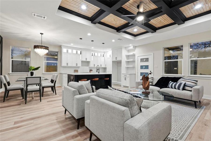 Living room with coffered ceiling, a chandelier, light wood-style floors, and wood ceiling Living room with coffered ceiling, a chandelier, light wood-style floors, and wood ceiling