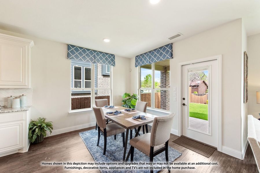 Dining area with wood table, four chairs, hardwood floors, and glass door leading to backyard