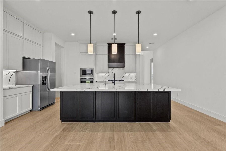 Chef’s eat-in island Kitchen features lengthy quartz countertops