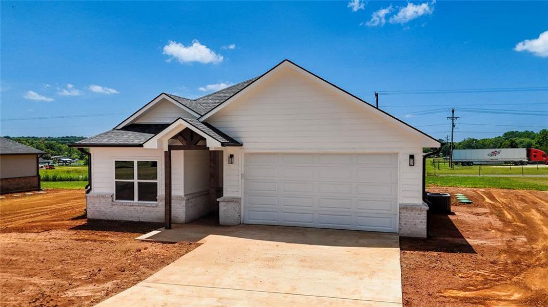Ranch-style house with concrete driveway, an attached garage, roof with shingles, and brick siding Ranch-style house with concrete driveway, an attached garage, roof with shingles, and brick siding
