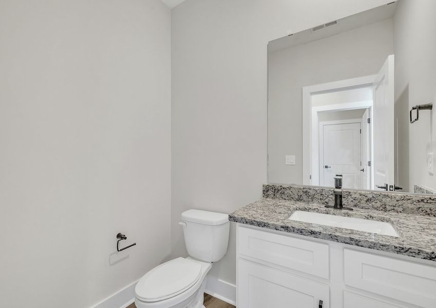 The secondary bathroom has granite countertops