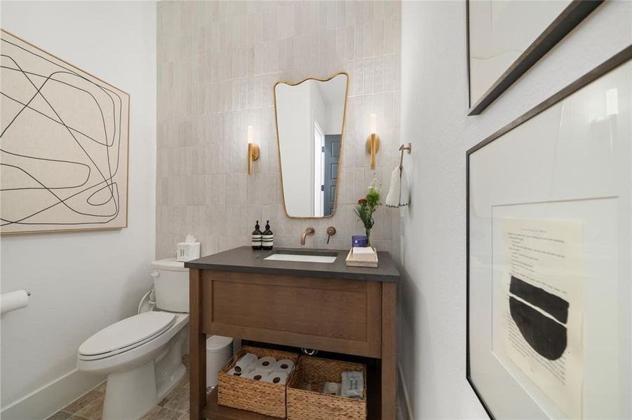 Bathroom with backsplash, vanity, tile walls, and toilet