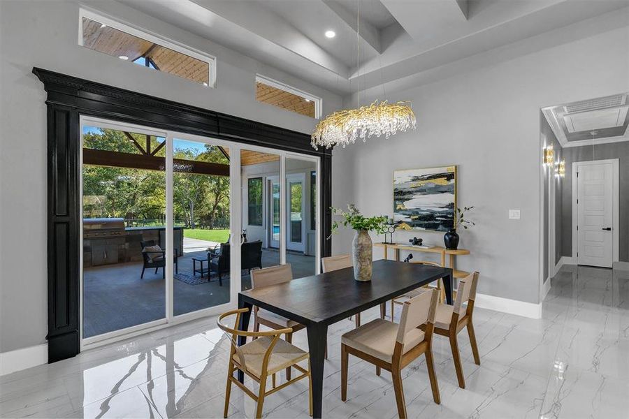 Dining space featuring a towering ceiling