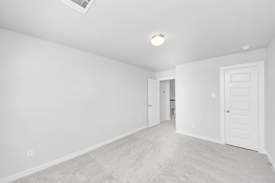 Generously sized secondary bedrooms featuring spacious closets, soft and inviting carpeting underfoot, large windows allowing plenty of natural light. Sample photo of completed home with similar plan. Actual colors and selections may vary. Call for more info.