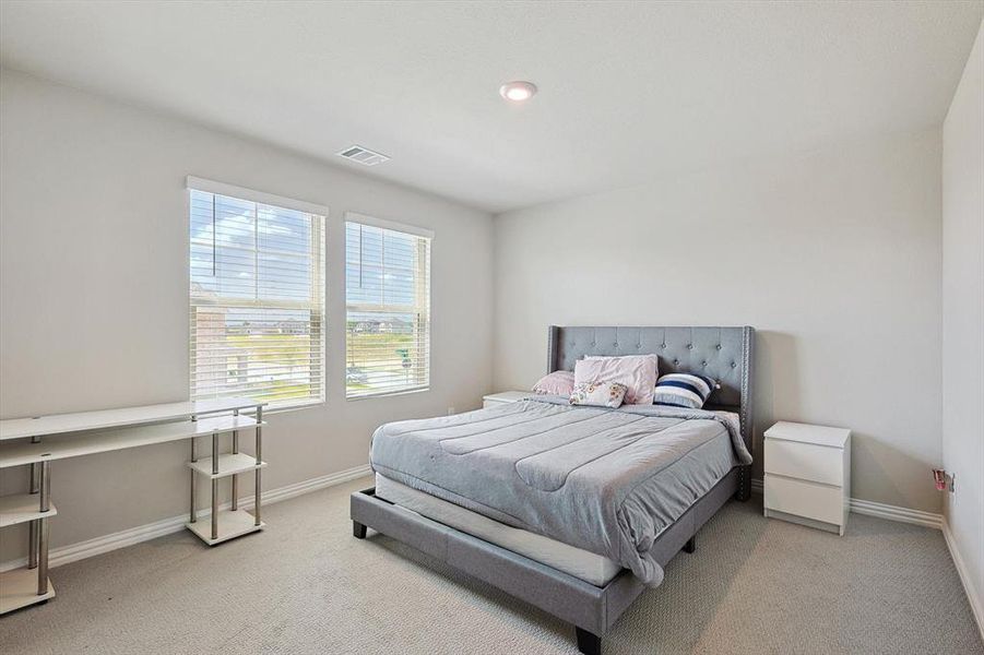 Bedroom with light carpet