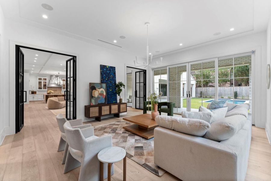 The family room features in-ceiling speakers, recessed lighting, and seamless access to the lush backyard The family room features in-ceiling speakers, recessed lighting, and seamless access to the lush backyard