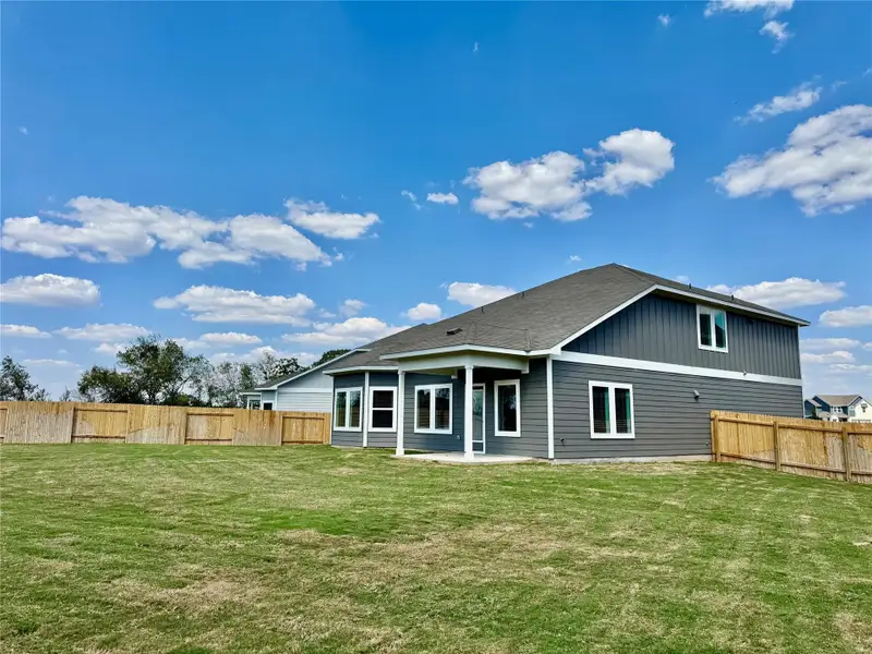 Rear view of property with a fenced backyard and a patio area Rear view of property with a fenced backyard and a patio area