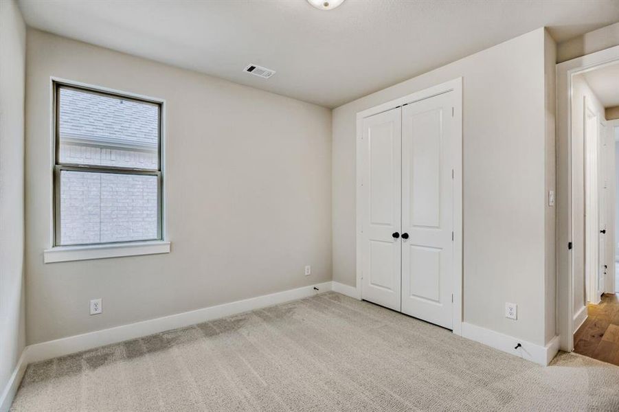 Unfurnished bedroom with carpet and a closet