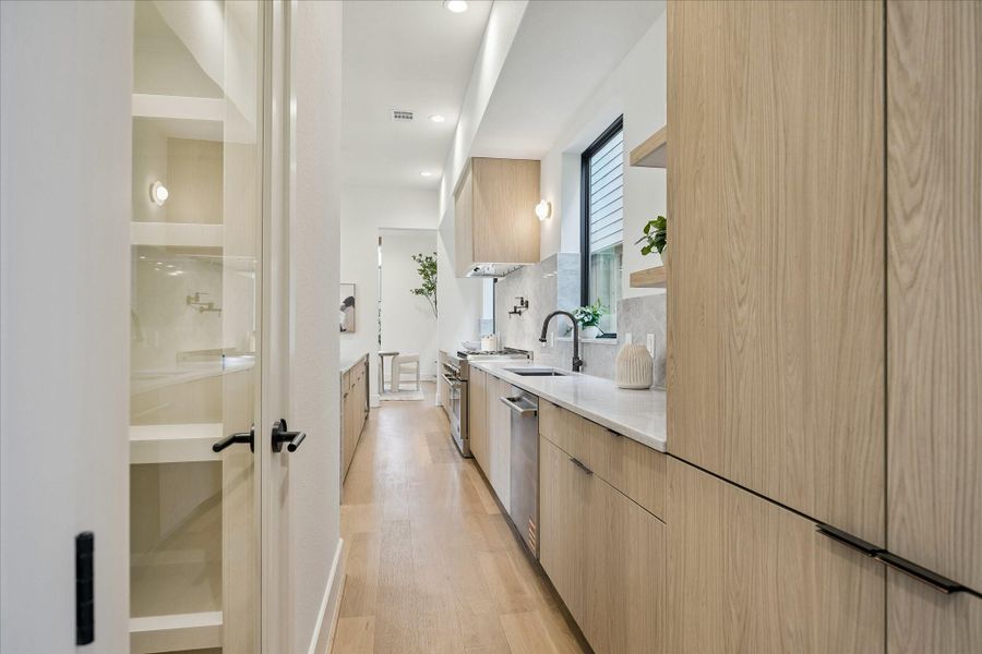Walk-in pantry with custom built-ins and glass door. Walk-in pantry with custom built-ins and glass door.