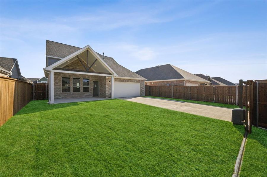 View of front facade with a front yard and a garage