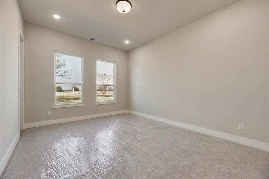 Unfurnished room with recessed lighting and light carpet
