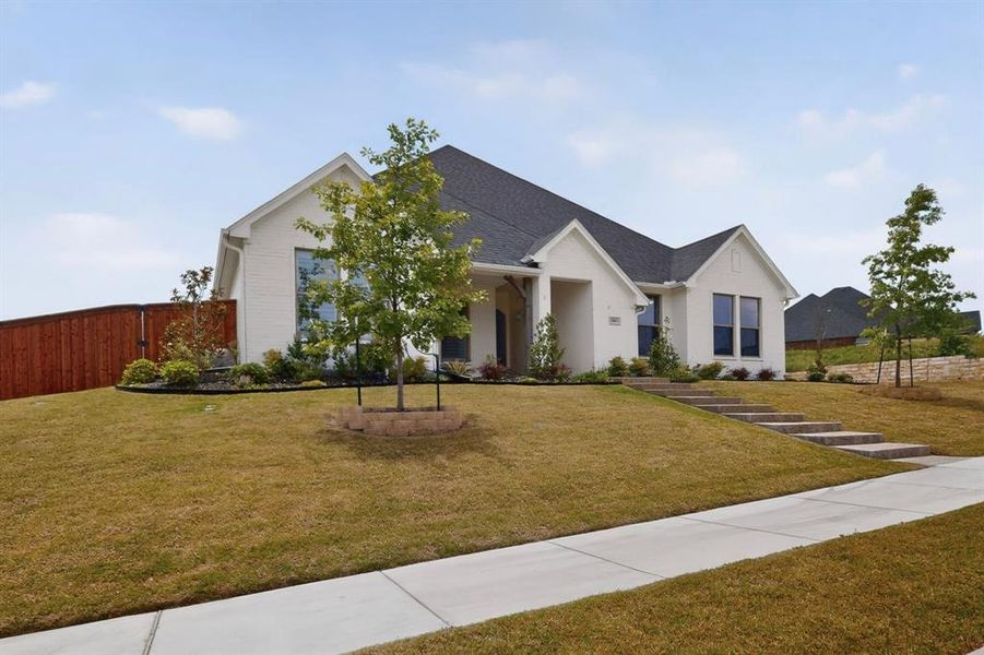 Contemporary single-story residence featuring a white brick facade and dark roof Contemporary single-story residence featuring a white brick facade and dark roof