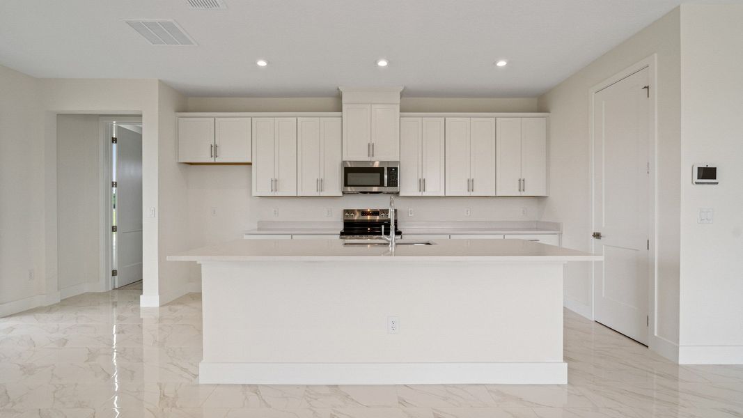 The Sweetgum Spacious and Bright Kitchen in two story home in Trailside in Mount Dora by DRB Homes
