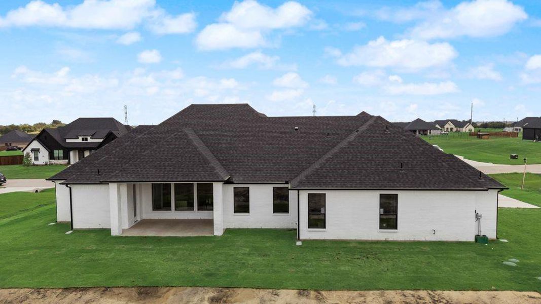 Rear view of house featuring a yard, a patio area, a residential view, and brick siding Rear view of house featuring a yard, a patio area, a residential view, and brick siding