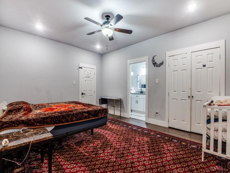 Bedroom featuring dark wood-type flooring, ceiling fan, a closet, ensuite bath, and recessed lighting Bedroom featuring dark wood-type flooring, ceiling fan, a closet, ensuite bath, and recessed lighting