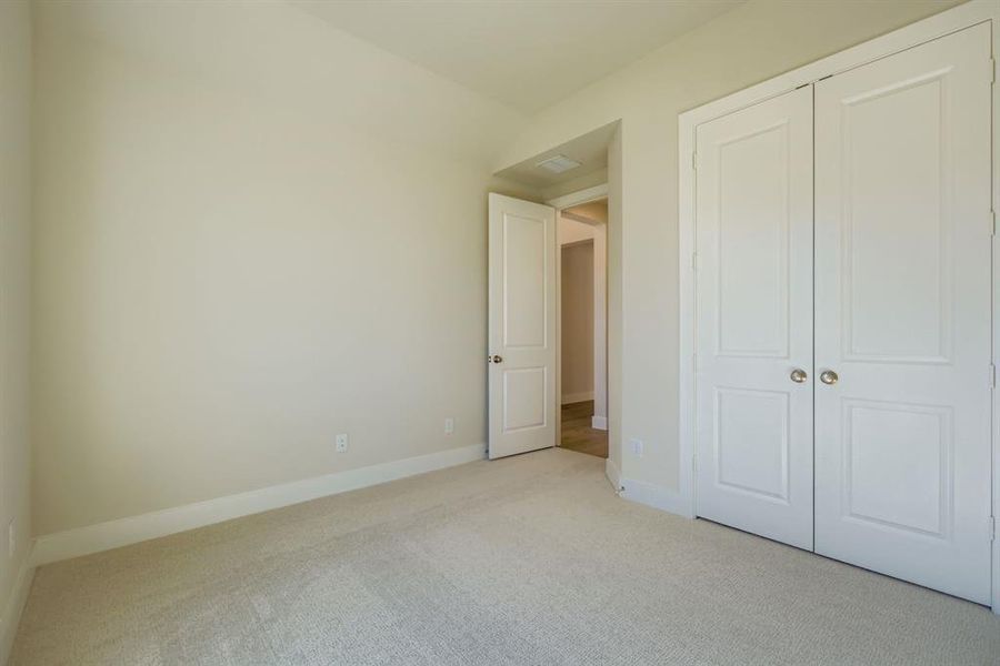 Unfurnished bedroom with carpet flooring and a closet