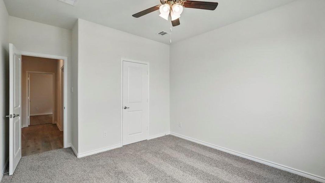 Unfurnished bedroom with carpet floors and a ceiling fan