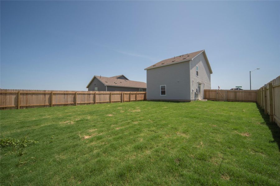 View of fenced backyard