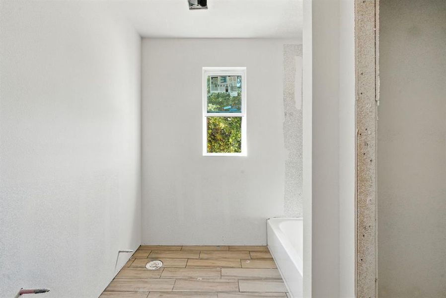 Bathroom with wood finish floors and a garden tub Bathroom with wood finish floors and a garden tub