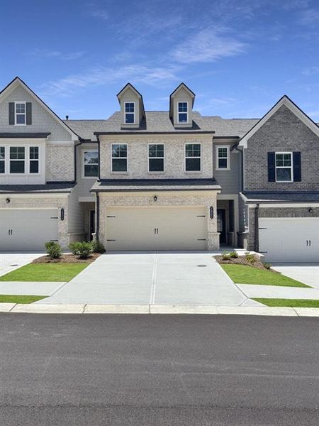 Front exterior of a new home in Towns at Ivy Creek, Buford, GA, highlighting curb appeal (Image 1).