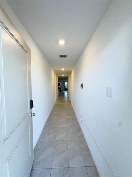 Corridor featuring recessed lighting and light tile patterned flooring
