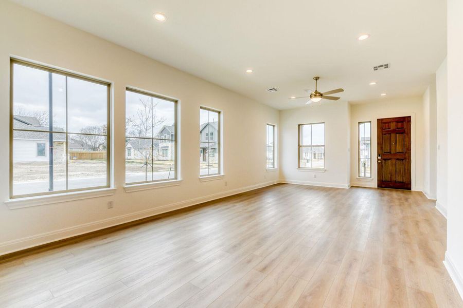 Unfurnished living room with recessed lighting, light wood-style floors, and a ceiling fan