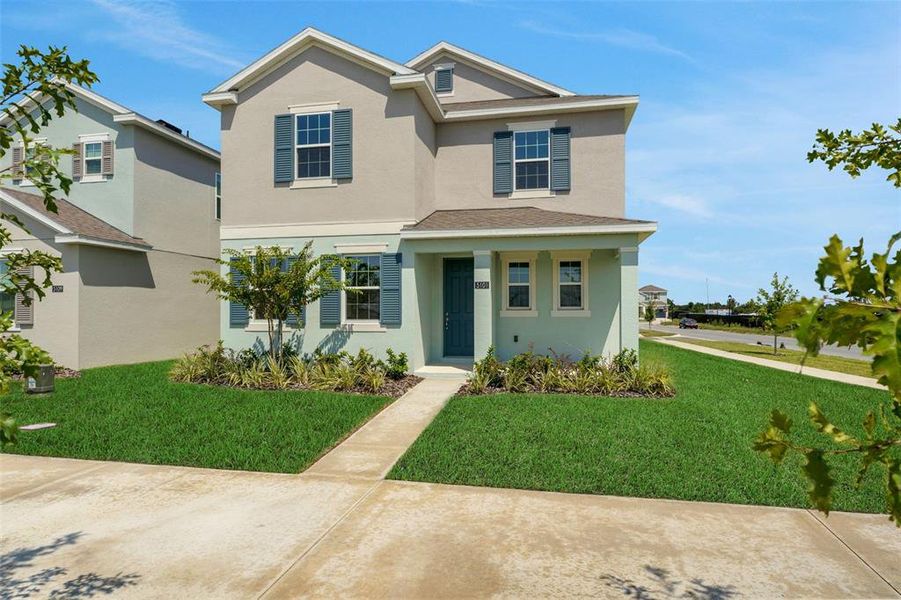 Front exterior of a new home in Crossroads at Kelly Park, Apopka, FL, highlighting curb appeal (Image 1).