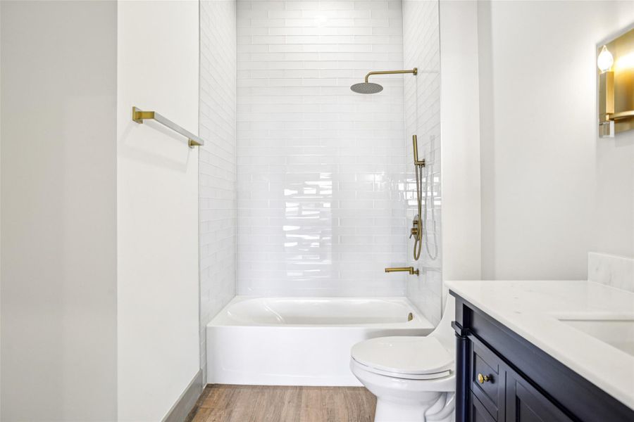 Bathroom with vanity, light wood-type flooring, and  shower combination