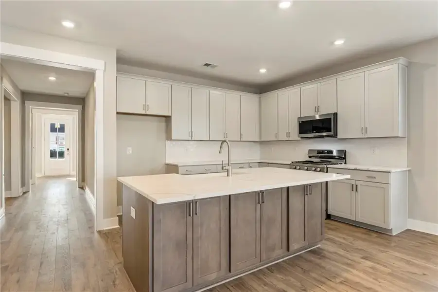 A well-lit kitchen with a large island and ample c