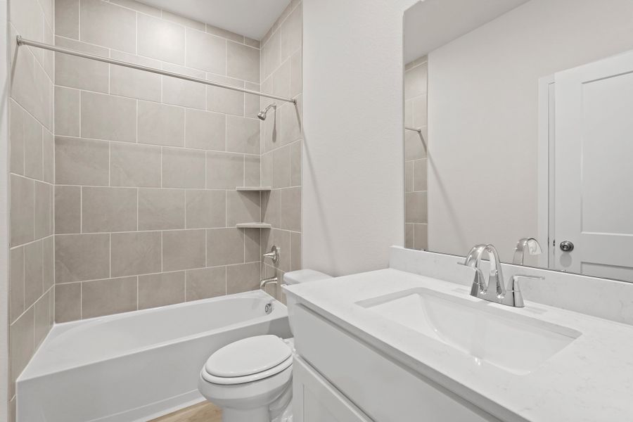 A bathroom with a tub sink and toilet. A bathroom with a tub sink and toilet.