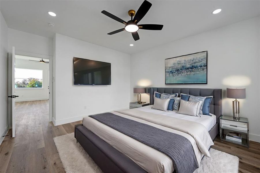 The oversized third bedroom with a full ensuite bath. The room is large enough for a king bed. The door opens to the flex space.