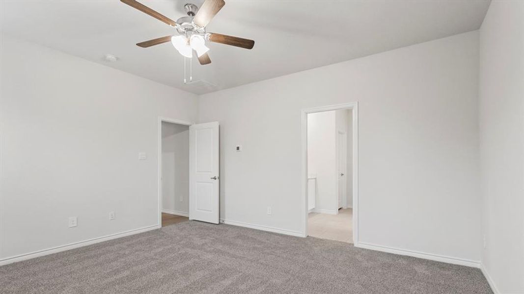 Unfurnished bedroom featuring carpet floors and ceiling fan Unfurnished bedroom featuring carpet floors and ceiling fan