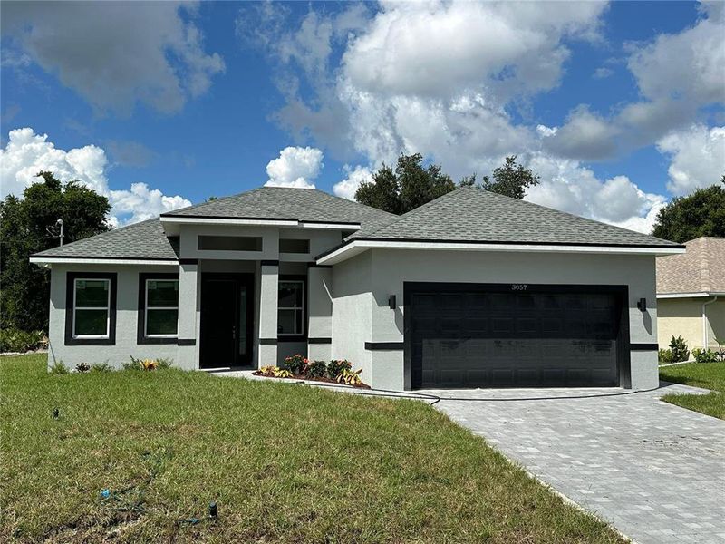 Front exterior of a new home in , North Port, FL, highlighting curb appeal (Image 1). Front exterior of a new home in , North Port, FL, highlighting curb appeal (Image 1).
