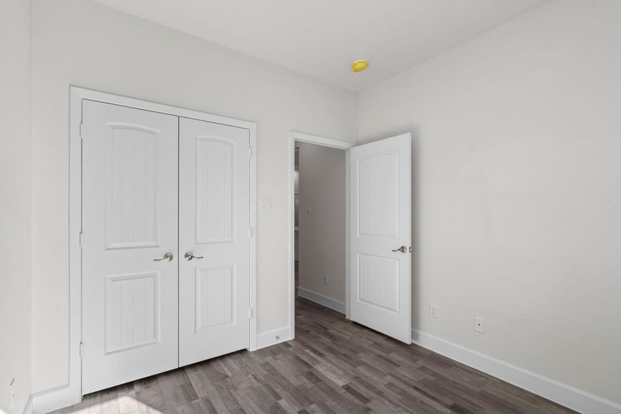 This bedroom is complete with a built-in closet.