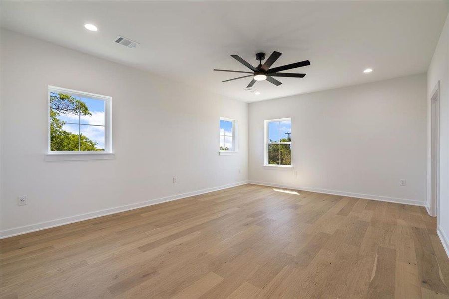 Empty room with recessed lighting, light wood finished floors, and ceiling fan