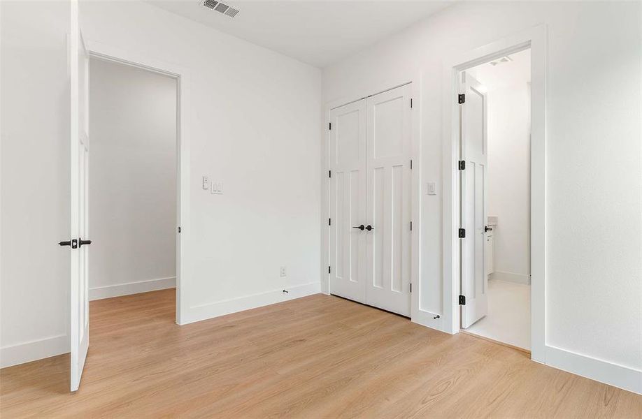 Unfurnished bedroom featuring light wood finished floors and a closet
