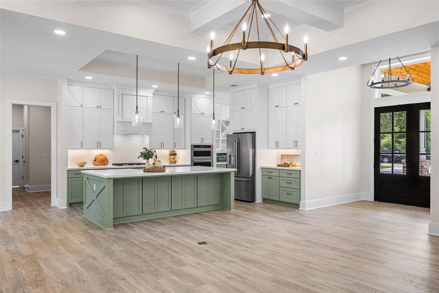 Storage Galore with Custom Built Cabinets to the Ceiling, Custom Vent Hood, Under Cabinet Lighting, and a Beautiful Walk-In Pantry and Wine Cabinet with a Second Sink and Prep Area.
