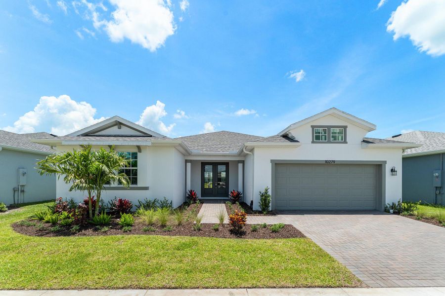 Front exterior of a new home in Tradition - Cadence, Port St. Lucie, FL, highlighting curb appeal (Image 1). Front exterior of a new home in Tradition - Cadence, Port St. Lucie, FL, highlighting curb appeal (Image 1).