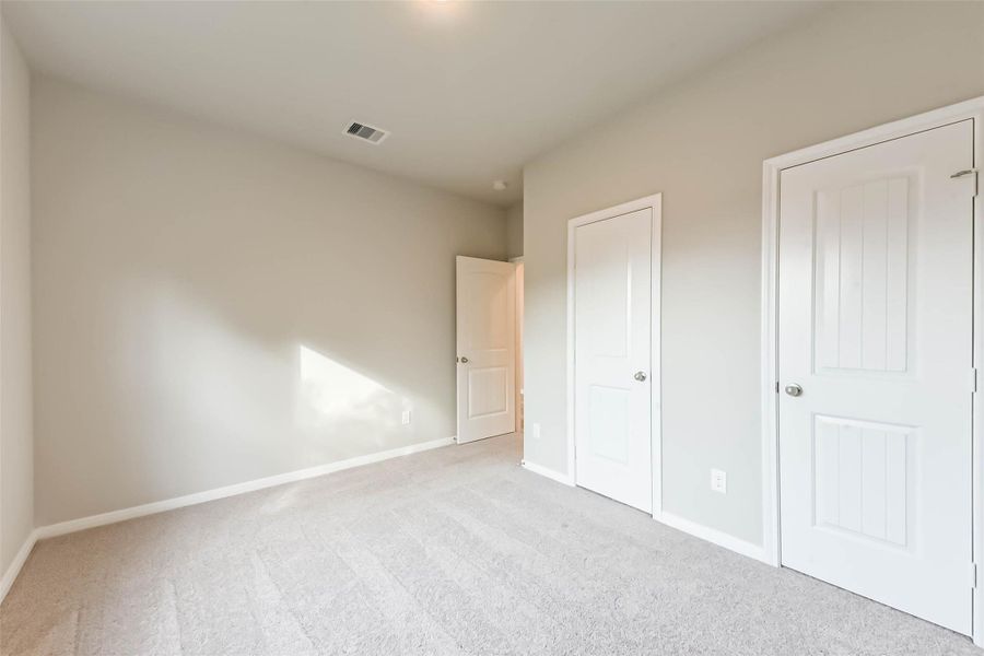The third bedroom provides ample space, cozy carpeting, and plenty of storage with generous closet space. The third bedroom provides ample space, cozy carpeting, and plenty of storage with generous closet space.