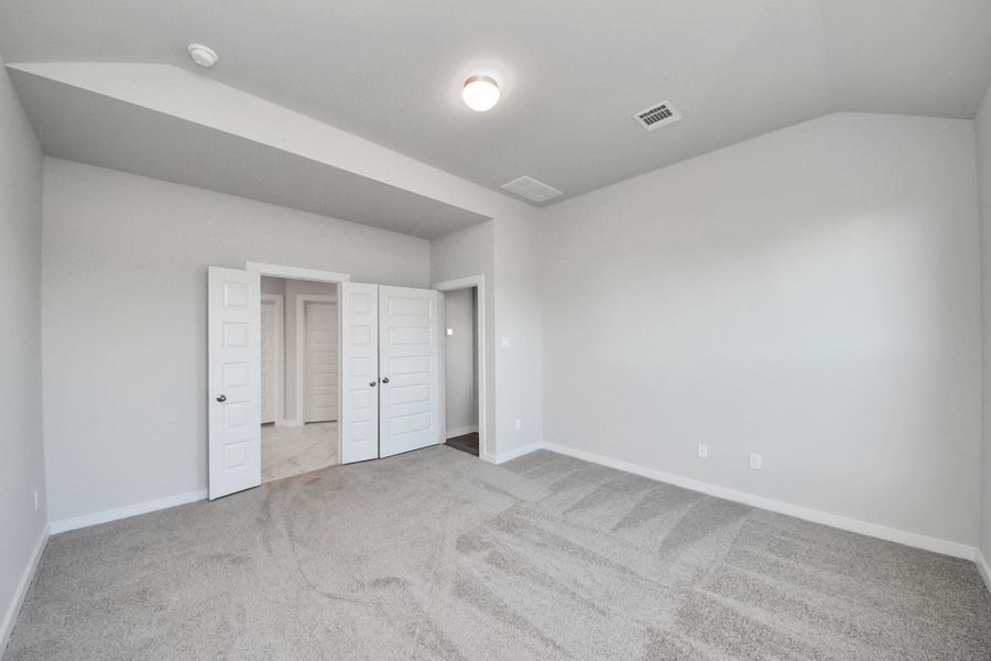 Escape and relax in the exquisite primary suite, a haven to unwind after a long day. The spacious room, boasts plush carpeting, soothing paint tones, high ceilings, and expansive windows adorned with privacy blinds.