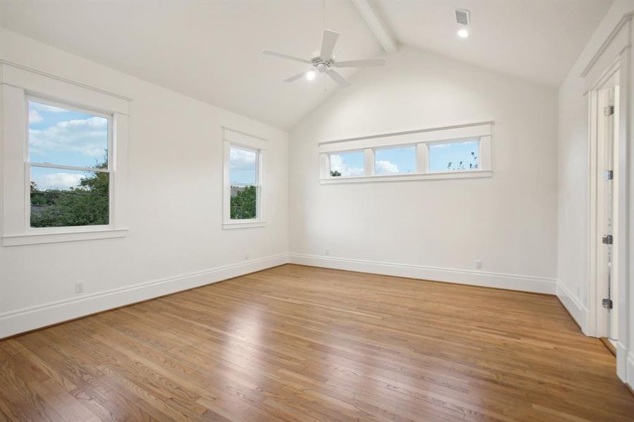 The primary bedroom can accomodate the bed on either of these two walls and features a vaulted ceiling.