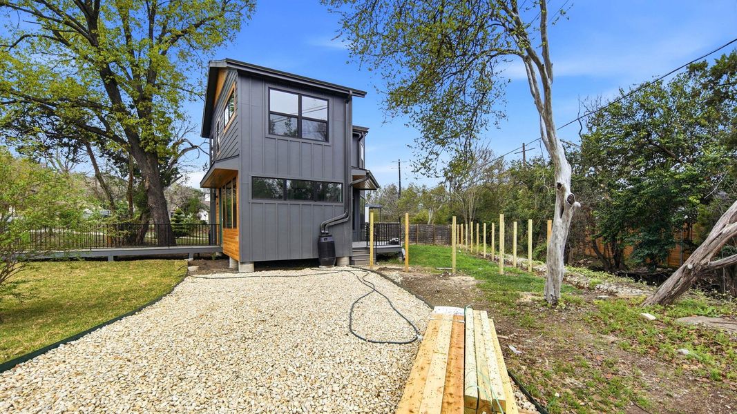 Rear view of house featuring a fenced backyard and board and batten siding