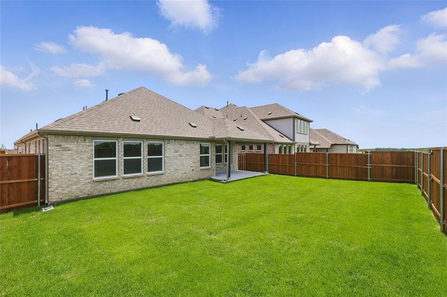 Rear view of property with brick siding, roof with shingles, and a patio Rear view of property with brick siding, roof with shingles, and a patio