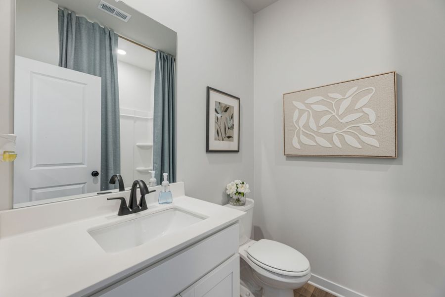 A bathroom with a sink and a toilet.